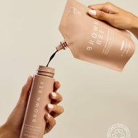 A hand pumping self-tanning mousse from the Brown Bee bottle