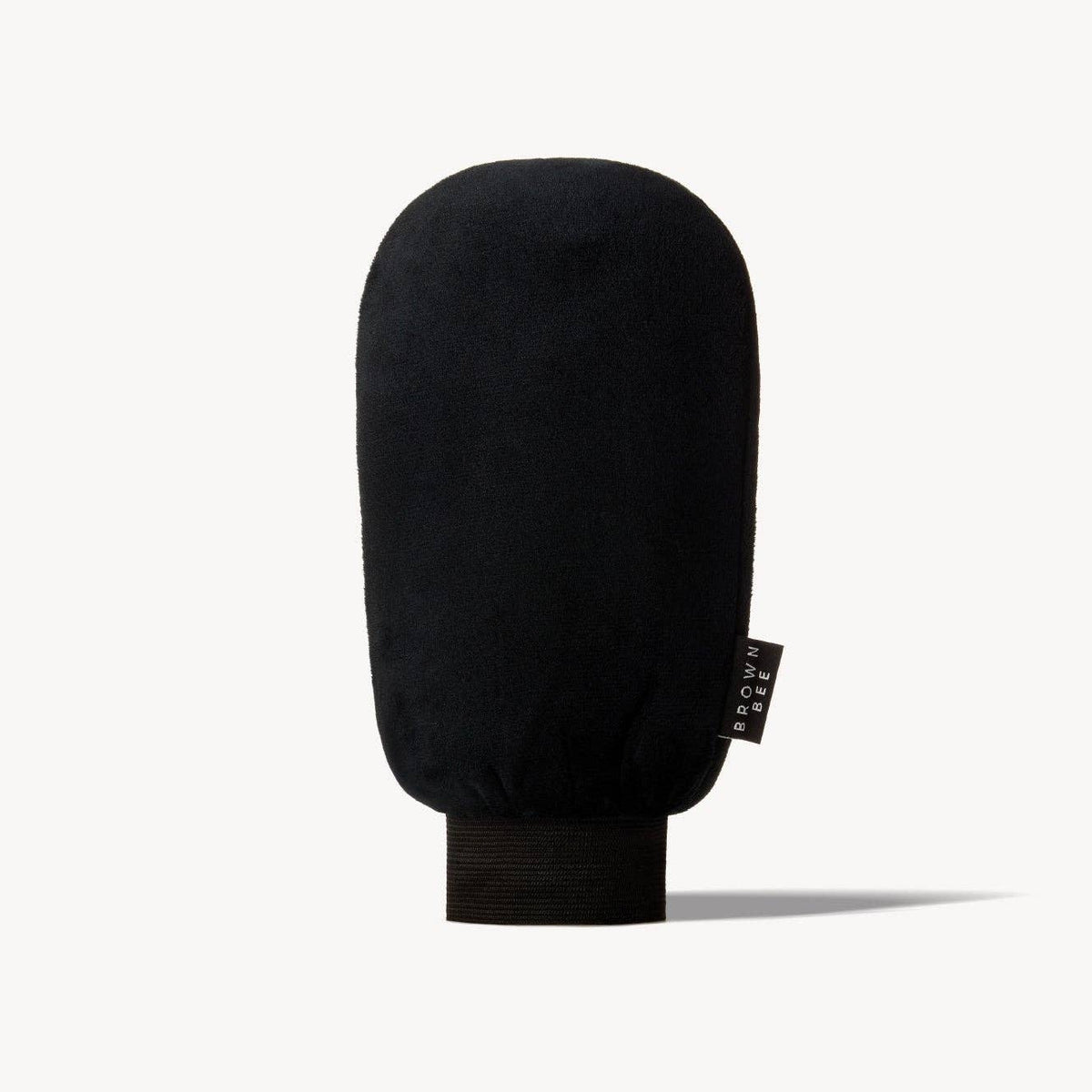 Black microfiber Brown Bee application mitt standing upright against a plain background