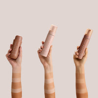 Forearms side by side showing increasing depth of color from the self-tanning mousse